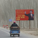 
              FILE - Chinese President Xi Jinping is seen on a billboard with the slogan, "Administer Xinjiang according to law, unite and stabilize the territory, culturally moisturize the territory, enrich the people and rejuvenate the territory, and build the territory for a long term," in Yarkent County in northwestern China's Xinjiang Uyghur Autonomous Region on March 21, 2021. Chinese characters in red reads "Building a Chinese Dream Together." China has responded furiously to a United Nations report on alleged human rights abuses in its northwestern Xinjiang region targeting Uyghurs and other mainly Muslim ethnic minorities. (AP Photo/Ng Han Guan, File)
            
