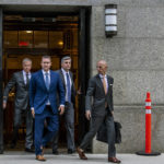 
              Trevor Milton, second from left, leaves the Thurgood Marshall United States Courthouse on Monday, Sept. 12, 2022, in New York. Jury selection began Monday in the fraud trial of Milton, the founder and former executive chairman of Nikola Corp accused of lying about the electric truck startup's vehicles. (AP Photo/Brittainy Newman)
            