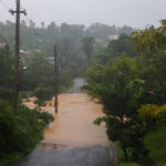 
              A road is flooded by the rains of Hurricane Fiona in Cayey, Puerto Rico, Sunday, Sept. 18, 2022. (AP Photo/Stephanie Rojas)
            