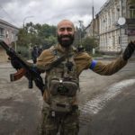 
              Ukrainian paratrooper Andrii Bashtovyi reacts as he see his comrades in the recently retaken area of Izium, Ukraine, Wednesday, Sept. 14, 2022. (AP Photo/Evgeniy Maloletka)
            