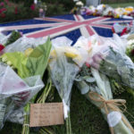 
              Flowers and cards are laid outside the British Embassy in Washington, Friday, Sept. 9, 2022. Queen Elizabeth II, Britain's longest-reigning monarch and a symbol of stability in a turbulent era that saw the decline of the British empire and disarray in her own family, died Thursday after 70 years on the throne. She was 96. (AP Photo/Jose Luis Magana)
            