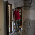 
              The head of the rapid response unit Taras Logginov walks in the damaged building of the Ukrainian Red Cross Society that was hit last week during a Russian attack in Sloviansk, Ukraine, Monday, Sept. 5, 2022. (AP Photo/Leo Correa)
            