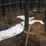 
              Bags with dead bodies are seen during the exhumation in the recently retaken area of Izium, Ukraine, Friday, Sept. 16, 2022. Ukrainian authorities discovered a mass burial site near the recaptured city of Izium that contained hundreds of graves. It was not clear who was buried in many of the plots or how all of them died, though witnesses and a Ukrainian investigator said some were shot and others were killed by artillery fire, mines or airstrikes. (AP Photo/Evgeniy Maloletka)
            