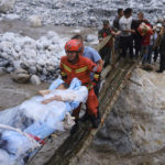 
              In this photo released by Xinhua News Agency, rescuers transfer survivors across a river following an earthquake in Moxi Town of Luding County, southwest China's Sichuan Province on Monday, Sept. 5, 2022. Dozens people were reported killed and missing in a 6.8 magnitude earthquake that shook China's southwestern province of Sichuan on Monday, triggering landslides and shaking buildings in the provincial capital of Chengdu, whose 21 million residents are already under a COVID-19 lockdown. (Cheng Xueli/Xinhua via AP)
            
