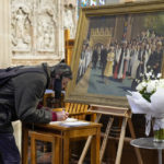 
              A man signs the condolence book at St Andrews Cathedral following the passing of Queen Elizabeth II in Sydney, Australia, Friday, Sept. 9, 2022. Queen Elizabeth II, Britain's longest-reigning monarch and a symbol of stability in a turbulent era for her country and the world, died Thursday, Sept. 8 after 70 years on the throne. She was 96. ((AP Photo/Mark Baker)
            