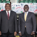 
              Kenya's new president William Ruto, right, poses after shaking hands with outgoing President Uhuru Kenyatta, left, as he is sworn in to office at a ceremony held at Kasarani stadium in Nairobi, Kenya, Tuesday, Sept. 13, 2022. Ruto was sworn in as Kenya's president on Tuesday after narrowly winning the Aug. 9 election and after the Supreme Court last week rejected a challenge to the official results by losing candidate Raila Odinga. (AP Photo/Brian Inganga)
            