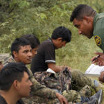 
              A group of migrants are processed after being apprehended by U.S. Border Patrol agents in the desert at the base of the Baboquivari Mountains, Thursday, Sept. 8, 2022, near Sasabe, Ariz. The desert region located in the Tucson sector just north of Mexico is one the deadliest stretches along the international border with rugged desert mountains, uneven topography, washes and triple-digit temperatures in the summer months. Border Patrol agents performed 3,000 rescues in the sector in the past 12 months. (AP Photo/Matt York)
            