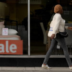 
              A pedestrian passes a shop advertising a sale in London, Friday, Sept. 23, 2022. Britain's new government on Friday announced a sweeping plan of tax cuts it said would be funded by borrowing and revenues generated by anticipated growth, as part of contentious moves to combat the cost-of-living crisis and bolster a faltering economy. (AP Photo/Kirsty Wigglesworth)
            