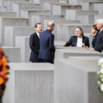 
              Israeli President Isaac Herzog, left, his wife Michal Herzog, 3rd left, German President Frank-Walter Steinmeier, right, and his wife Elke Buedenbender, 2nd right, and Deputy director of the Holocaust memorial Ulrich Baumann, 2nd left, talk together after a wreath laying ceremony at the Holocaust memorial in Berlin, Germany, Tuesday, Sept. 6, 2022. (AP Photo/Christoph Soeder)
            