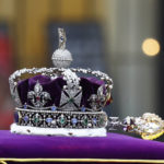 
              The crown lies on the coffin of Britain's Queen Elizabeth II as it is carried into the Westminster Abbey, during her funeral in London Monday, Sept. 19, 2022. (Hannah McKay/Pool Photo via AP)
            