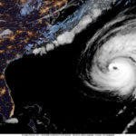 This image provided by the National Hurricane Center National Oceanic and Atmospheric Administration shows a satellite view as Hurricane Fiona moves up the United States Atlantic coast, Thursday night, Sept. 22, 2022. Hurricane Fiona pounded Bermuda with heavy rains and winds as it swept by the island on a route that has it reaching northeastern Canada as a still-powerful storm late Friday. (NOAA via AP)