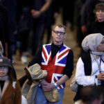 
              A man wears a shirt with the British flag as he files past the coffin of Queen Elizabeth II during the lying in State inside Westminster Hall, at the Palace of Westminster in London, Sunday, Sept. 18, 2022.  (Jeff J Mitchell/Pool Photos via AP)
            