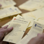 
              Poll workers count votes at a polling station at Hästhagens Sport Center in Malmö, Sweden, Sunday, Sept. 11, 2022. An exit poll projected that Sweden’s ruling left-wing Social Democrats have won the most votes in a general election Sunday, while a right-wing populist party had its best showing yet. (Johan Nilsson/TT News Agency via AP)
            