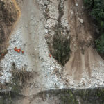 
              In this photo released by Xinhua News Agency, rescuers transfer an earthquake affected villager through a damaged mountain road near Moxi Town of Luding County, southwest China's Sichuan Province Wednesday, Sept. 7, 2022. The death toll in this week's earthquake in western China has jumped to more than dozen with plenty still missing, the government reported Wednesday, as frustration rose with uncompromising COVID-19 lockdown measures that prevented residents from leaving their buildings after the shaking. (Shen Bohan/Xinhua via AP)
            