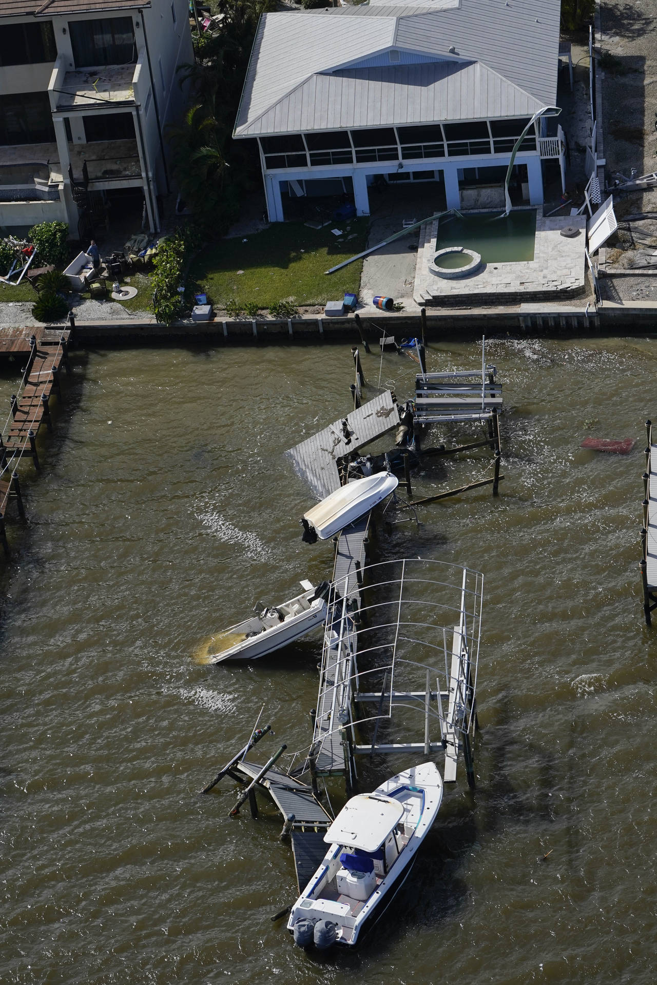 Boats and a damged home are seen in the aftermath of Hurricane Ian, Thursday, Sept. 29, 2022, in Fo...