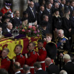 
              Britain's Queen Elizabeth's coffin is carried as King Charles III, Camilla, the Queen Consort and Princess Anne follow, during the funeral in London, Monday Sept. 19, 2022. (Phil Noble/Pool Photo via AP)
            