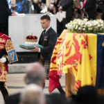 
              The Duke of Hamilton, center, carries the Crown of Scotland to be placed on the coffin of Queen Elizabeth II during a Service of Prayer and Reflection for her life at St Giles' Cathedral, Edinburgh, Monday, Sept. 12, 2022. (Jane Barlow/Pool Photo via AP)
            