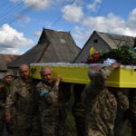 
              Soldiers carry the coffin of their comrade, Ukrainian military officer Volodumur Linsky, who was killed in a battle against Russian troops, in Kramatorsk, Ukraine, Saturday, Sept. 24, 2022. (AP Photo/Andriy Andriyenko)
            
