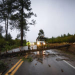 
              Caltrans workers remove a fallen tree blocking transit on SR-79 between Paso Picacho Campground and Lake Cuyamaca on Friday, Sept. 9, 2022 in San Diego, Calif. A surge of clouds and showers associated with Tropical Storm Kay off Mexico's Baja California peninsula knocked the edge off temperatures in Southern California at times but also were a potential problem for solar generation. The storm was downgraded from a hurricane Thursday evening. (Nelvin C. Cepeda/The San Diego Union-Tribune via AP)
            