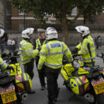 
              Police officers wait in Westminster in London, Sunday, Sept. 18, 2022,The funeral of Britain's Queen Elizabeth II will take place in Westminster on Monday. (AP Photo/Vadim Ghirda)
            