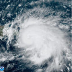 
              This satellite image provided by NOAA shows Hurricane Fiona in the Caribbean on Sunday, Sept. 18, 2022. The eye of newly formed Hurricane Fiona is near the coast of Puerto Rico — and it has already sparked an island-wide blackout and threatens to dump “historic” levels of rain. (NOAA via AP)
            