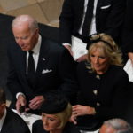 
              US President Joe Biden accompanied by the First Lady Jill Biden arrive for the State Funeral of Queen Elizabeth II, held at Westminster Abbey, London, Monday, Sept. 19, 2022. (Gareth Fuller/Pool Photo via AP)
            