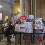 
              FILE - Abortion-rights protesters fill Indiana Statehouse corridors outside legislative chambers on Aug. 5, 2022, as lawmakers vote to concur on a near-total abortion ban, in Indianapolis. Indiana’s new abortion ban will make nearly all abortions illegal in the state as of Thursday, Sept. 15, putting into effect a law that made it the first state where the Legislature and governor approved such a measure since the U.S. Supreme Court overturned Roe v. Wade in June. (AP Photo/Arleigh Rodgers, File)
            