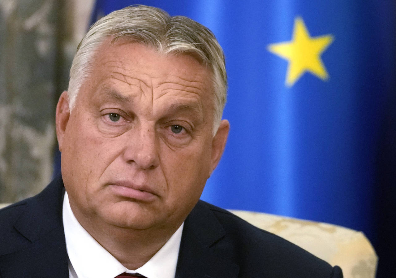 Hungary's Prime Minister Viktor Orban listens to Serbian President Aleksandar Vucic during their ta...