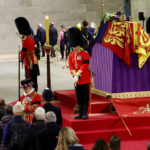 
              Royal guards stand by the coffin of Britain's Queen Elizabeth II, as members of the public pay their respects, following her death, during her lying-in-state at Westminster Hall, in Westminster Palace, in London, Sunday, Sept. 18, 2022. (Sarah Meyssonnier/Pool Photo via AP)
            