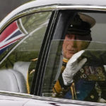 
              King Charles III waves as he is driven to Westminster Abbey for the funeral of her mother, Queen Elizabeth II, in central London Monday Sept. 19, 2022. The Queen, who died aged 96 on Sept. 8, will be buried at Windsor alongside her late husband, Prince Philip, who died last year. (AP Photo/Alberto Pezzali)
            