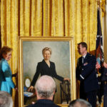
              FILE - Former President Bill Clinton, left, and President George W. Bush and first lady Laura Bush, right, applaud as former first lady Sen. Hillary Clinton's portrait is unveiled during a ceremony at the White House, June 14, 2004. (AP Photo/Dennis Cook, File)
            