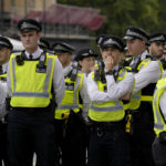 
              Police officers wait in Westminster in London, Sunday, Sept. 18, 2022,The funeral of Britain's Queen Elizabeth II will take place in Westminster on Monday. (AP Photo/Vadim Ghirda)
            
