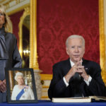 
              President Joe Biden speaks after signing a book of condolence at Lancaster House in London, following the death of Queen Elizabeth II, Sunday, Sept. 18, 2022, as first lady Jill Biden looks on. (AP Photo/Susan Walsh)
            