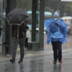 
              People walk in the rain as Typhoon Hinnamnor moves toward the Korean Peninsula in Seoul, South Korea, Monday, Sept. 5, 2022. Hundreds of flights were grounded and more than 200 people evacuated in South Korea on Monday as Typhoon Hinnamnor approached the country's southern region with heavy rains and winds of up to 290 kilometers (180 miles) per hour, the strongest storm in decades. (AP Photo/Lee Jin-man)
            