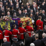 
              Britain's Queen Elizabeth's coffin is carried inside the Westminster Abbey, during her funeral in London, Monday Sept. 19, 2022. (Phil Noble/Pool Photo via AP)
            