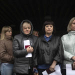 
              People wait to attend voting in a referendum in front of a mobile polling station in Luhansk, eastern Ukraine, Friday, Sept. 23, 2022. Voting began Friday in four Moscow-held regions of Ukraine on referendums to become part of Russia. (AP Photo)
            