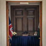 
              A condolence book is kept beside a picture of Queen Elizabeth II at the residence of British High Commissioner, in New Delhi, India, Friday, Sept. 9, 2022. Queen Elizabeth II, Britain's longest-reigning monarch and a rock of stability across much of a turbulent century, died Thursday after 70 years on the throne. She was 96. (AP Photo/Altaf Qadri)
            