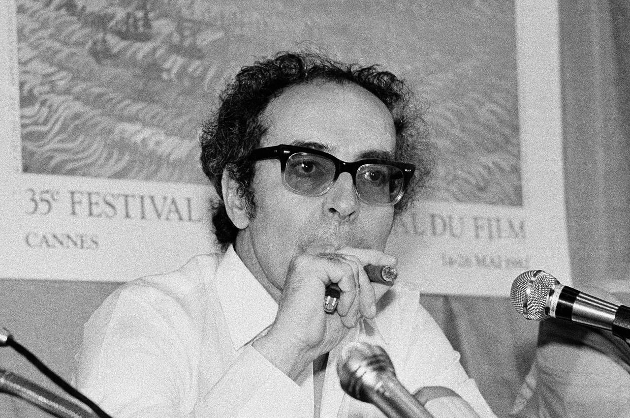 FILE - Film director Jean-Luc Godard smokes at Cannes festival, France on May 25, 1982. Director Je...