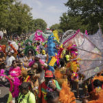 Participants in costume walk during the West Indian Day Parade, Monday, Sept. 5, 2022, in the Brooklyn borough of New York. (AP Photo/Yuki Iwamura)