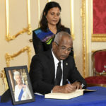 
              President of the Maldives Ibrahim Mohamed Solih signs a book of condolences as First Lady Fazna Ahmed stands next to him at Lancaster House, following the death of Queen Elizabeth II, in London, Sunday, Sept. 18, 2022. ( Jonathan Hordle/Pool Photo via AP)
            