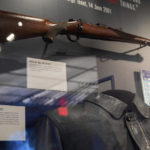 
              A Ruger M77 bolt action rifle brandished by Iraqi dictator Saddam Hussein is displayed along with the Saddam's leather jacket when he was captured by American forces is on display at the Central Intelligence Agency headquarters building's refurbished museum in Langley, Va., on Saturday, Sept. 24, 2022. (AP Photo/Kevin Wolf)
            