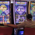 
              A man plays a slot machine at the Hard Rock Casino in Atlantic City N.J. on Aug. 8, 2022. On Sept. 16, 2022, New Jersey gambling regulators reported that the state's casinos, horse tracks that offer sports betting and the online partners of both types of gambling outlets won $470.6 million from gamblers in August, up nearly 10% from a year earlier. (AP Photo/Wayne Parry)
            