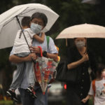 
              People walk in the rain ahead of the approaching Typhoon Muifa in Taipei, Taiwan, Monday, Sept. 12, 2022. (AP Photo/Chiang Ying-ying)
            