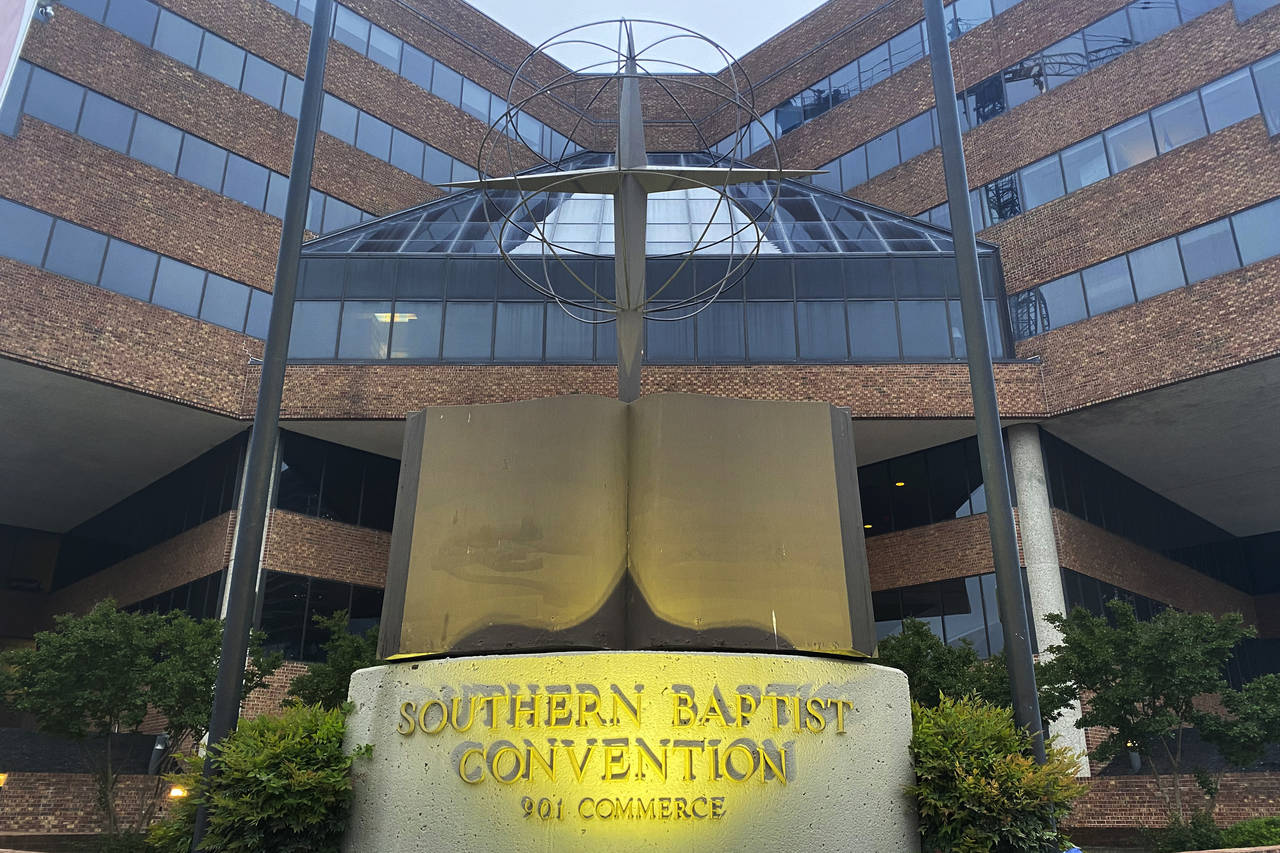 FILE - A cross and Bible sculpture stand outside the Southern Baptist Convention headquarters in Na...
