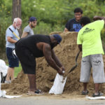 
              Residents fill sandbags at Barnett Park, Tuesday, Sept. 27, 2022, in Orlando, Fla., to prepare for the arrival of hurricane Ian. (Ricardo Ramirez Buxeda/Orlando Sentinel via AP)
            