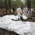 
              Experts work during the exhumation of bodies in the recently retaken area of Izium, Ukraine, Friday, Sept. 16, 2022. Ukrainian authorities discovered a mass burial site near the recaptured city of Izium that contained hundreds of graves. It was not clear who was buried in many of the plots or how all of them died, though witnesses and a Ukrainian investigator said some were shot and others were killed by artillery fire, mines or airstrikes. (AP Photo/Evgeniy Maloletka)
            