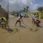 
              Locals clear mud brought by Hurricane Fiona in the Los Sotos neighborhood of Higuey, Dominican Republic, Tuesday, Sept. 20, 2022. (AP Photo/Ricardo Hernandez)
            