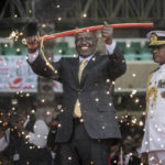 
              Kenya's new president William Ruto holds up a ceremonial sword as he is sworn in to office at a ceremony held at Kasarani stadium in Nairobi, Kenya Tuesday, Sept. 13, 2022. William Ruto was sworn in as Kenya's president on Tuesday after narrowly winning the Aug. 9 election and after the Supreme Court last week rejected a challenge to the official results by losing candidate Raila Odinga. (AP Photo/Brian Inganga)
            