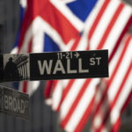 
              A Wall Street sign hangs in front of the New York Stock Exchange, Friday, Sept. 16, 2022, in New York.  Stocks fell broadly in afternoon trading on Wall Street Friday, putting the market on track for another week of sizable losses. (AP Photo/Yuki Iwamura)
            