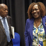 Mayor Acquanetta Warren, right, of Fontana, Calif., laughs while listening to Houston Mayor Sylvester Turner after a voting rights breakout session Tuesday, Sept. 20, 2022, in Houston. The National Nonpartisan Conversation on Voting Rights is holding meetings and seminars in Houston Tuesday and Wednesday. (AP Photo/David J. Phillip)